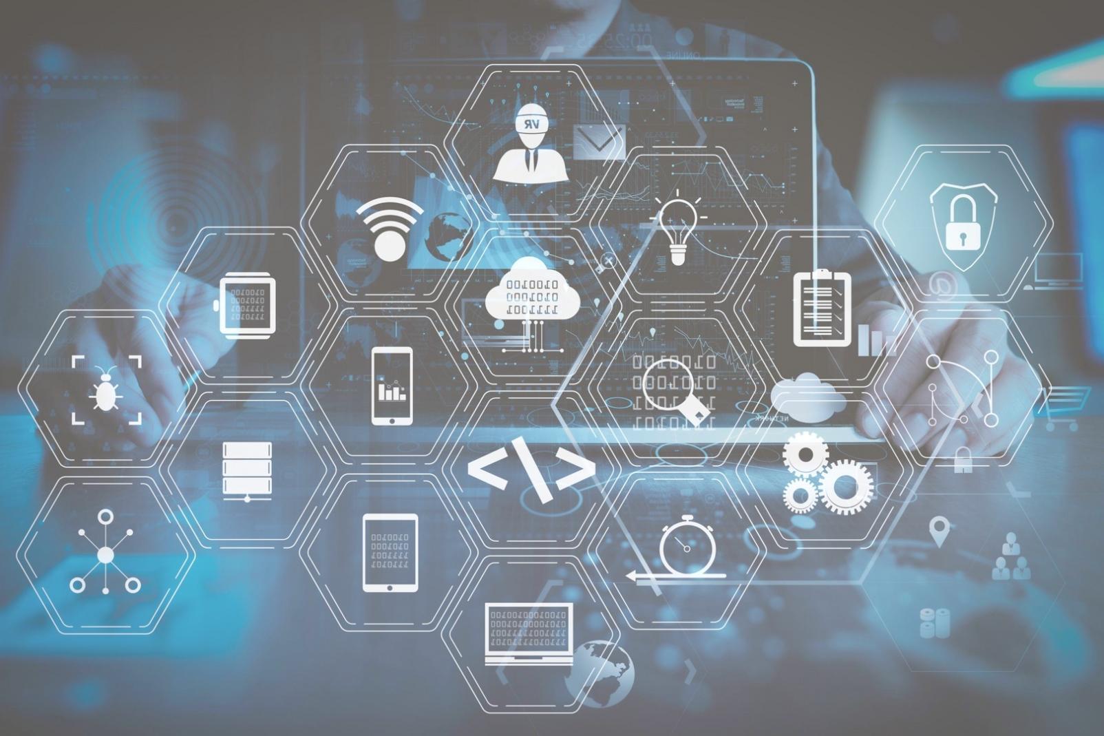 Developer reviewing authentication code on multiple monitors